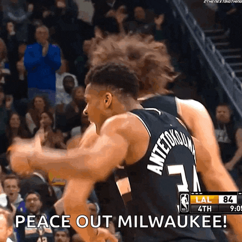 a basketball player with antetokounmpo on the back of his jersey celebrates