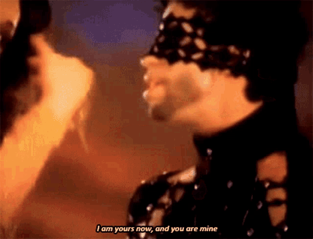 a man with a mask on his face says " i am yours now and you are mine "