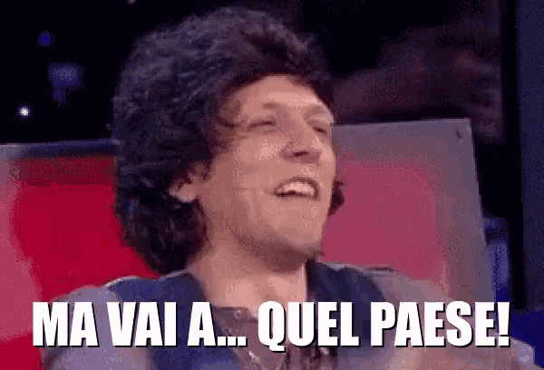 a man in a wig is laughing with the words ma vai a quel paese