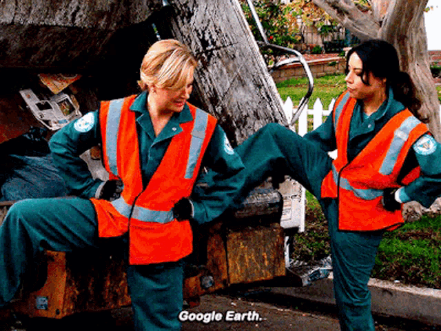 two garbage collectors are standing next to each other with google earth written on the bottom of the photo