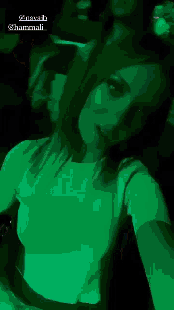 a woman in a white shirt is taking a picture