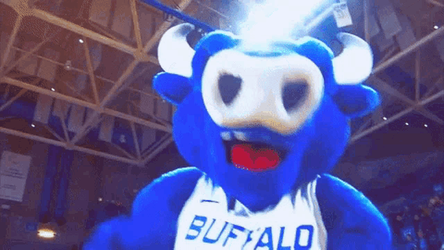 a blue buffalo mascot wearing a white shirt with the word buffalo on it