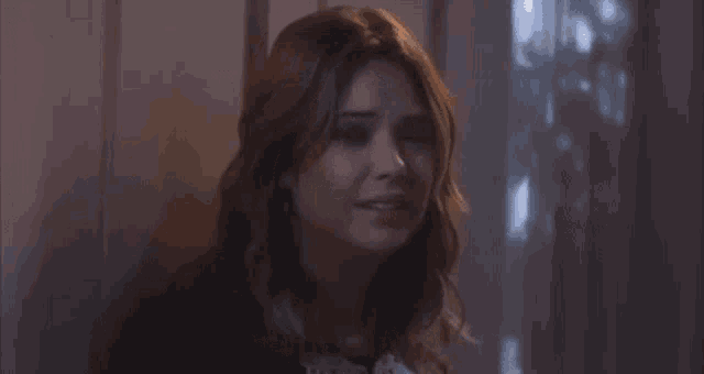 a woman is crying and saying `` is this how it works '' in a dark room .