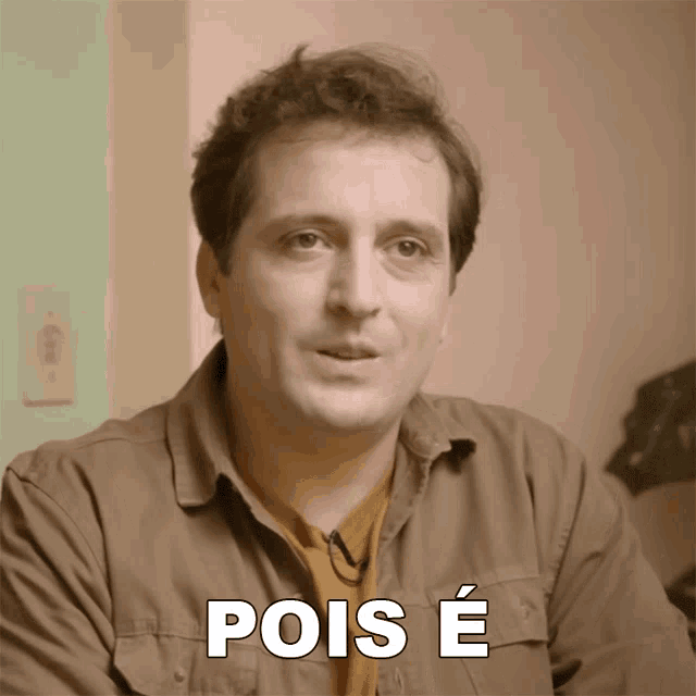 a man in a brown shirt has the word pois e on his chest