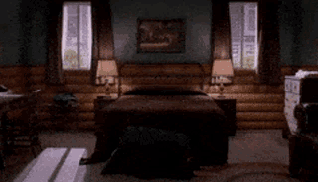a bedroom in a log cabin with a king size bed