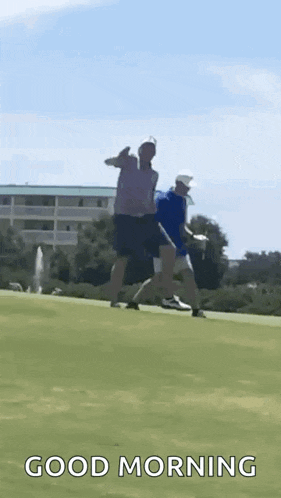 two men are playing golf on a golf course and one of them is giving a thumbs up .