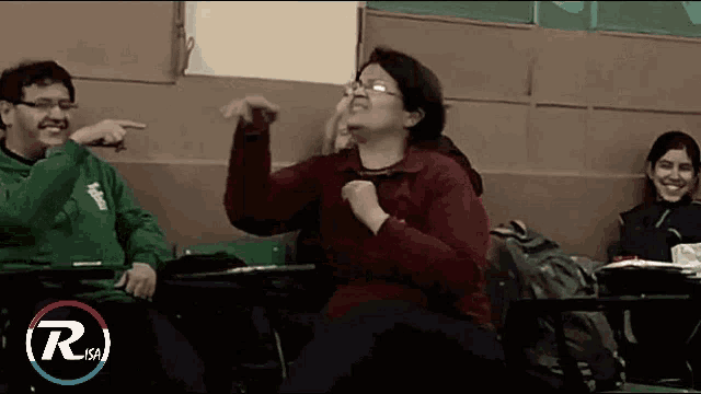 a man in a green sweatshirt is pointing at a woman