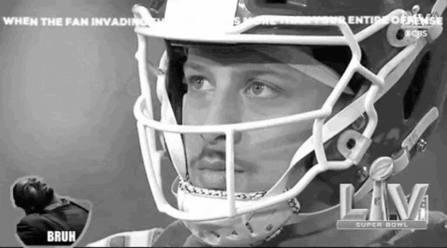 a black and white photo of a football player wearing a white helmet .