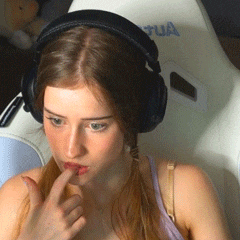 a woman wearing headphones sits in front of a chair with the word tua on it