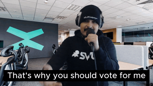 a man singing into a microphone with the words that 's why you should vote for me on the bottom