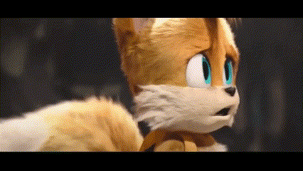 a close up of a stuffed animal with blue eyes and a surprised look on his face .