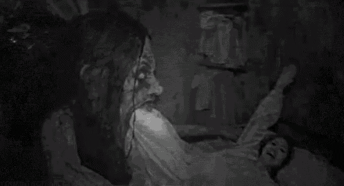 a black and white photo of a person 's face in a dark room with a lot of noise .