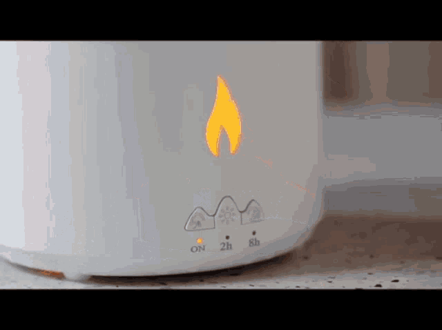 a white device with a flame on it and the words on 2h 8h