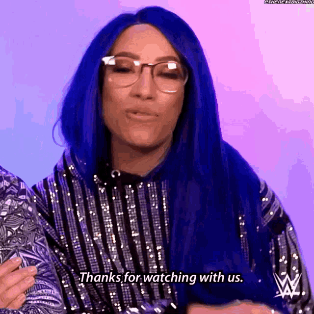 a woman with blue hair is wearing glasses and says thanks for watching with us