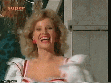 a woman in a white dress is laughing in front of a sign that says super .