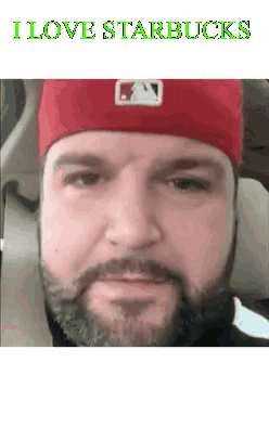 a man with a beard is wearing a red hat and says i love starbucks