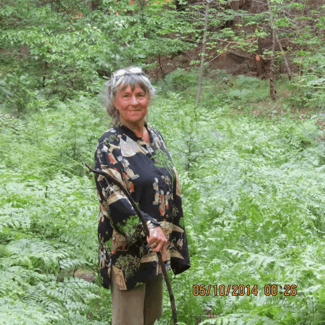 a woman stands in a field of ferns with a photo taken on 05/10/2014