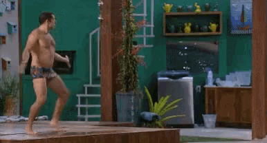 a person is jumping into a pool of water in a kitchen .