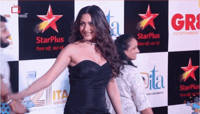 a woman stands in front of a starplus sign