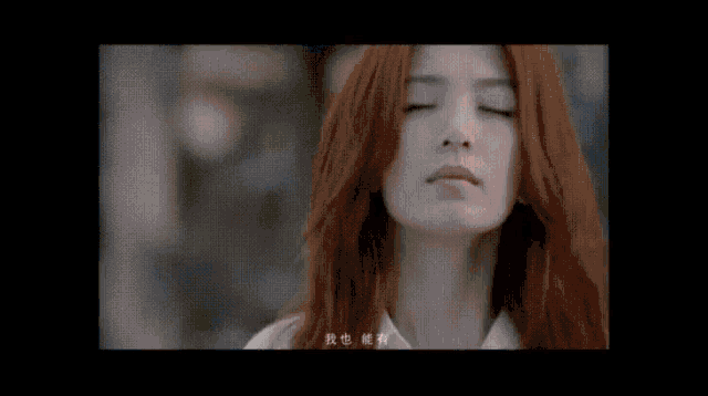 a close up of a woman 's face with red hair