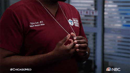 a man wearing a chicago medical center scrub shirt