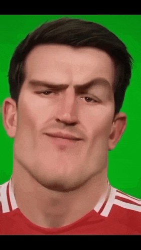 a close up of a man 's face with a green screen behind him .