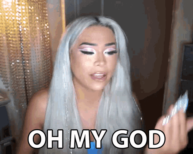 a woman with white hair says oh my god while holding a card