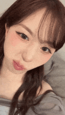 a close up of a woman 's face with a serious look on her face