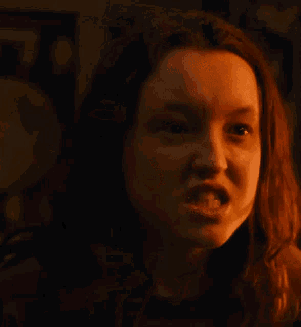 a close up of a woman 's face with her mouth open .