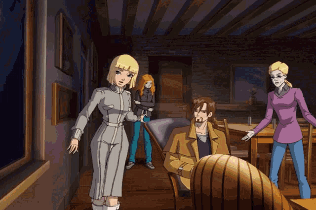 a group of people are standing in a room with a man sitting at a table