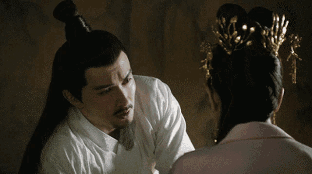 a man with a beard and a woman with a crown on her head