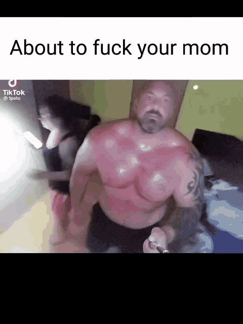 a man without a shirt is standing in front of a woman and a sign that says about to fuck your mom .