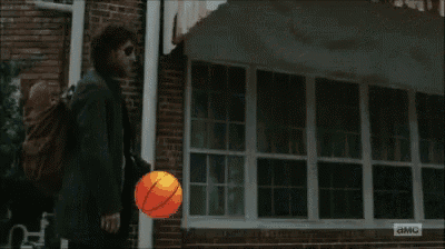 a man holding a basketball in front of a building that says ' u.s. army '