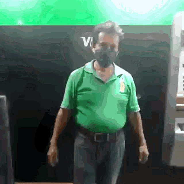 a man wearing a mask stands in front of an atm machine