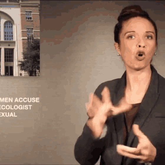 a woman in front of a sign that says men accuse ecologist sexually