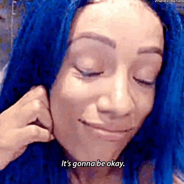 a woman with blue hair is smiling and says it 's gonna be okay .