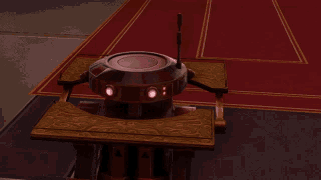 a robot sitting on a wooden table with red lights on it