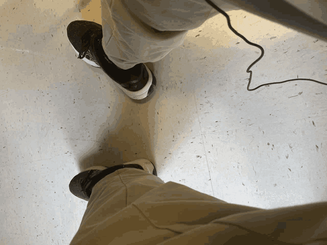 a person standing on a white tile floor