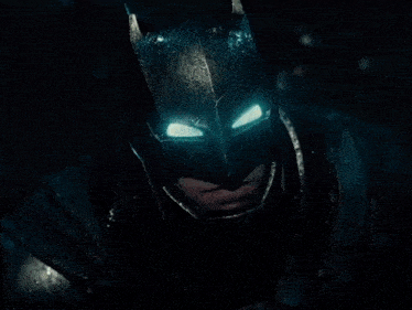 a close up of a man in a batman costume
