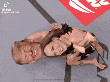 a woman is laying on top of a man in a cage with a tiktok watermark on the bottom
