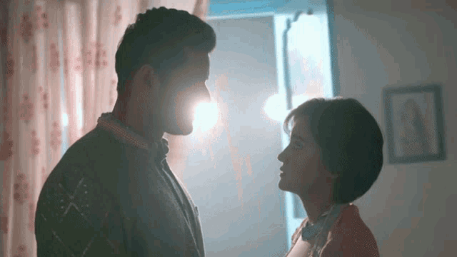 a man and a woman are looking into each others eyes
