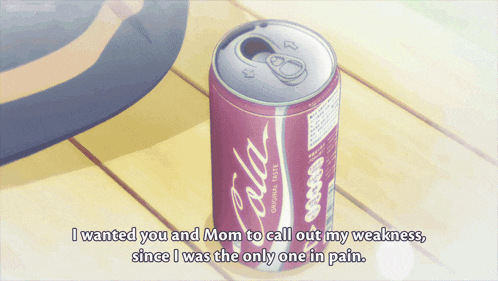 a can of cola sits on a wooden surface