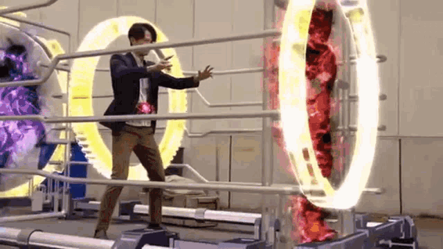 a man in a suit is standing on a treadmill in front of a machine with a glowing circle .