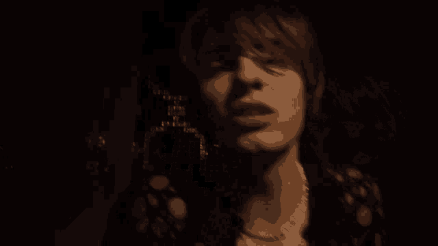 a blurry image of a dark room with a few lights on