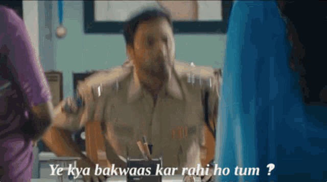 a man sitting at a desk with the words ye kya bakwaas kar rahi ho tum