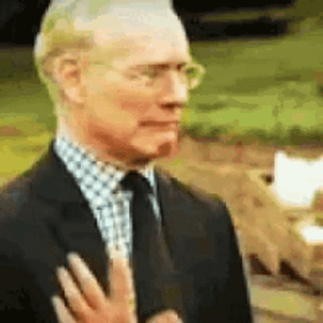 a man in a suit and tie is being interviewed by a woman