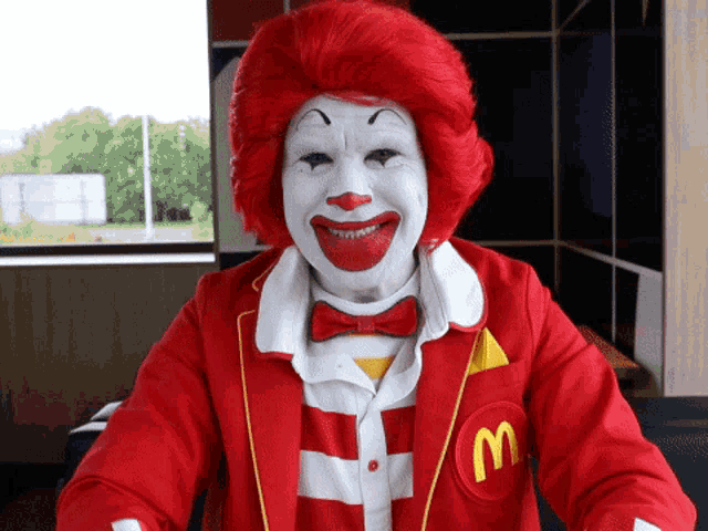 a man dressed as mcdonald 's ronald mcdonald with red hair