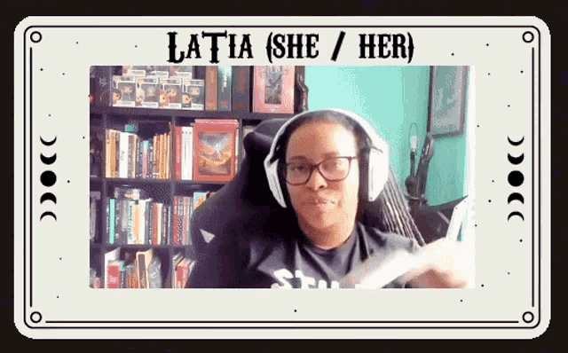 a woman wearing headphones is sitting in front of a bookshelf with the words latia ( she / her ) on it