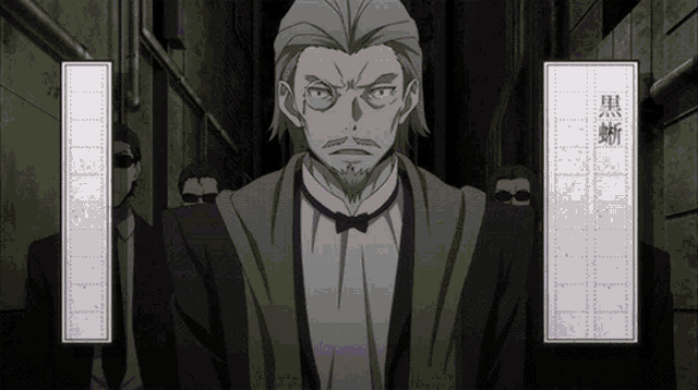 a man in a tuxedo and bow tie stands in a dark alley