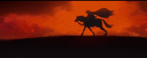 a silhouette of a man riding a horse with a red background